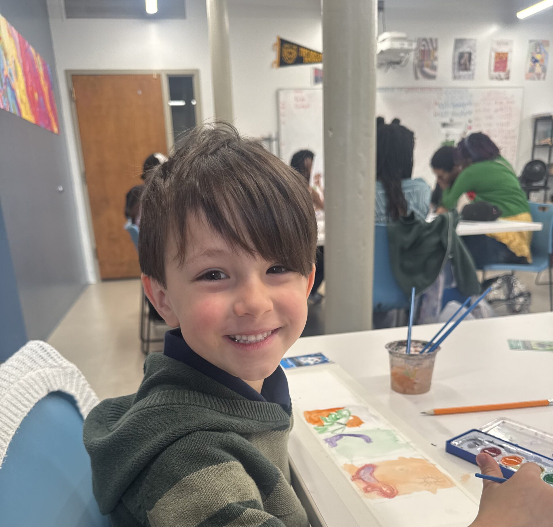 Young student drawing on paper smiling