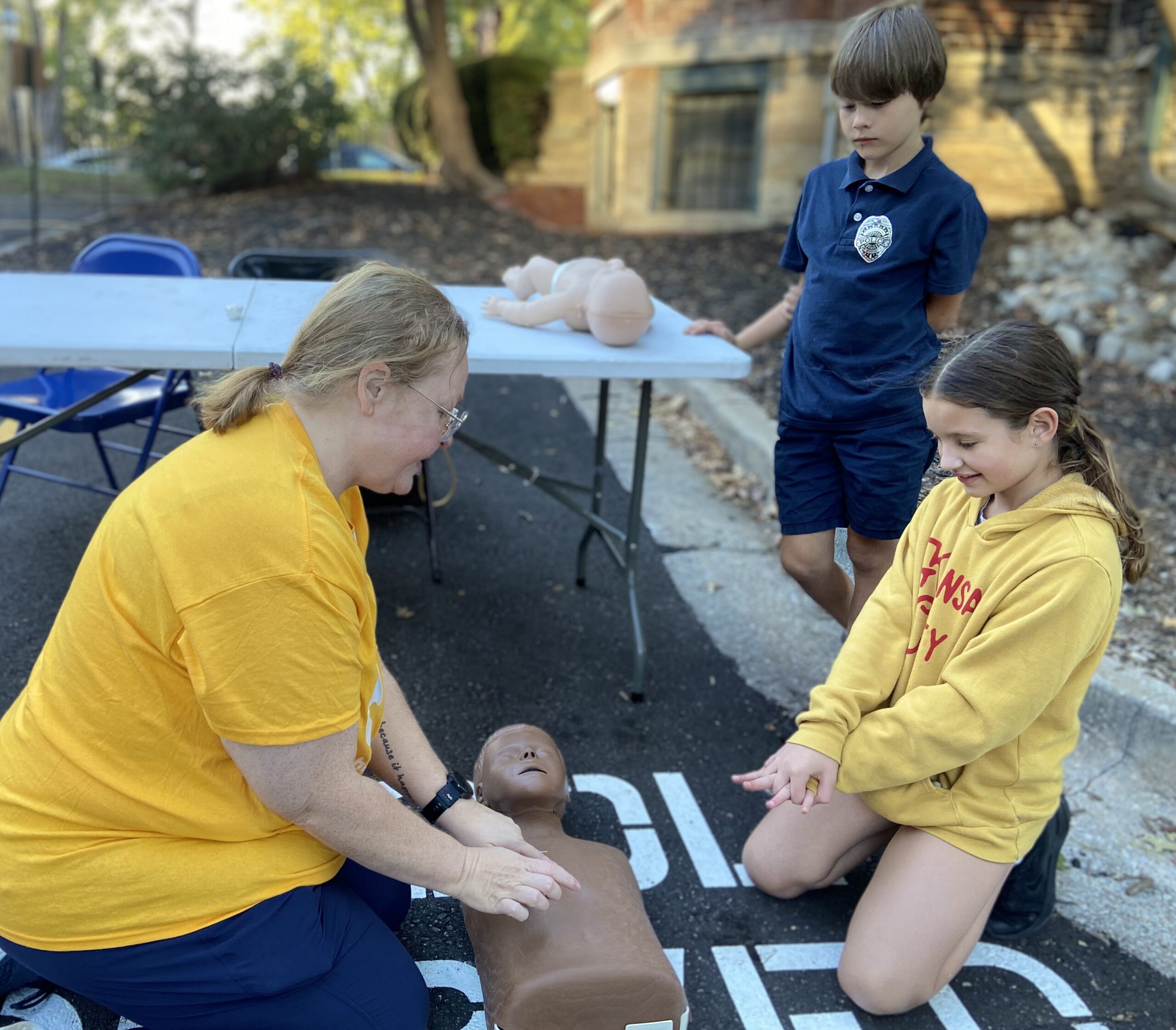 Teacher is teaching students how to give CPR